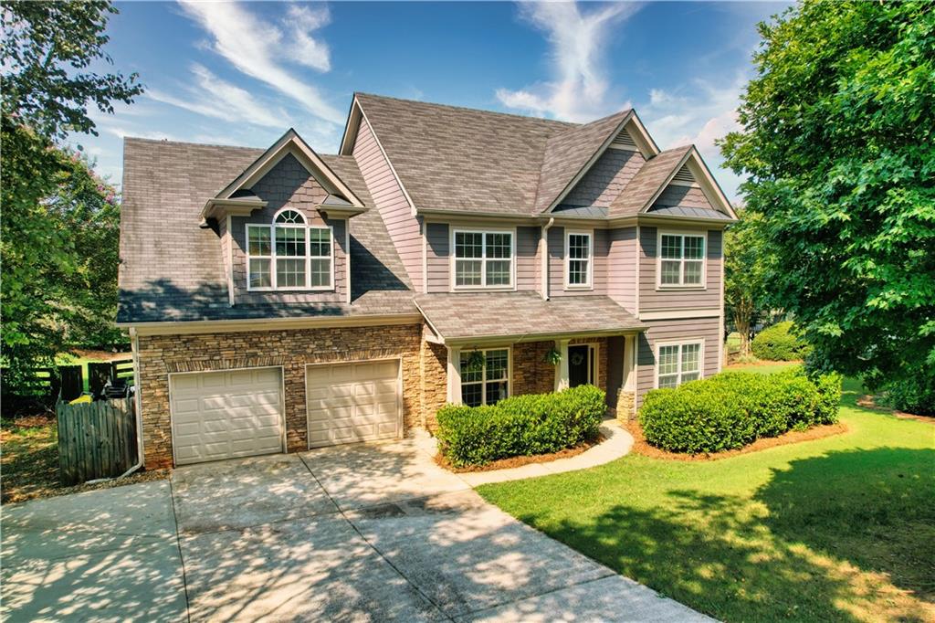 a front view of a house with a yard