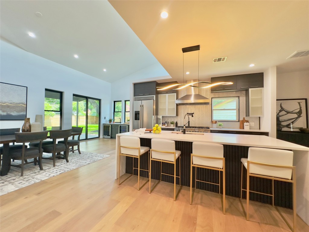 a large kitchen with a table and chairs