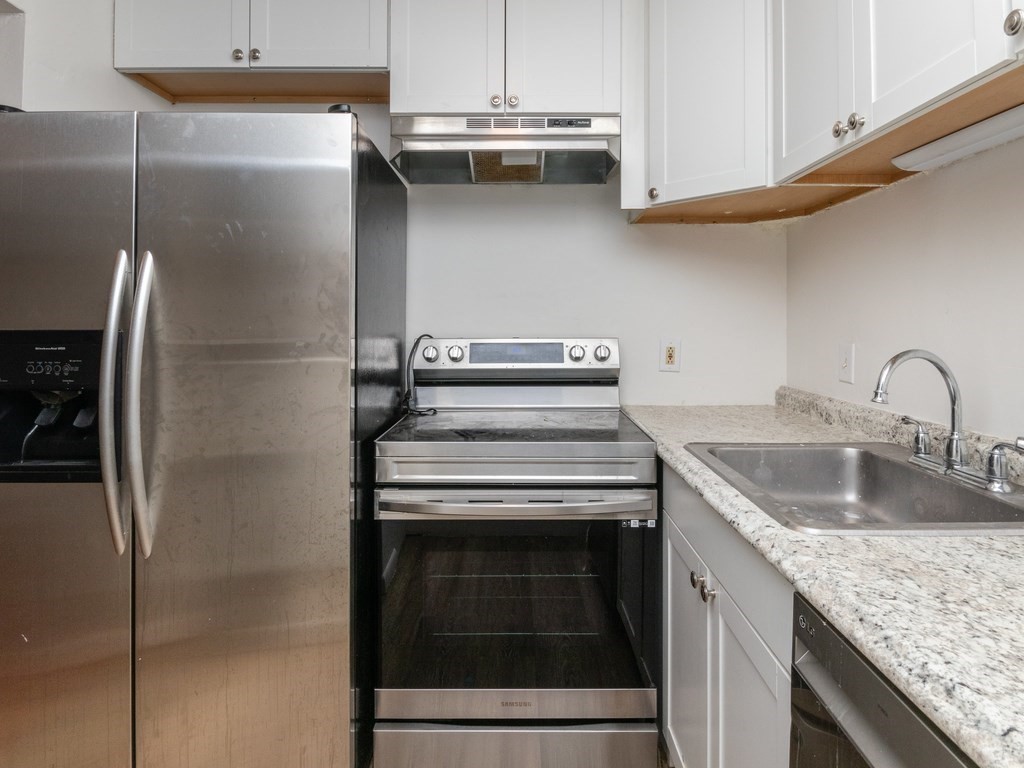 a kitchen with a sink and a refrigerator