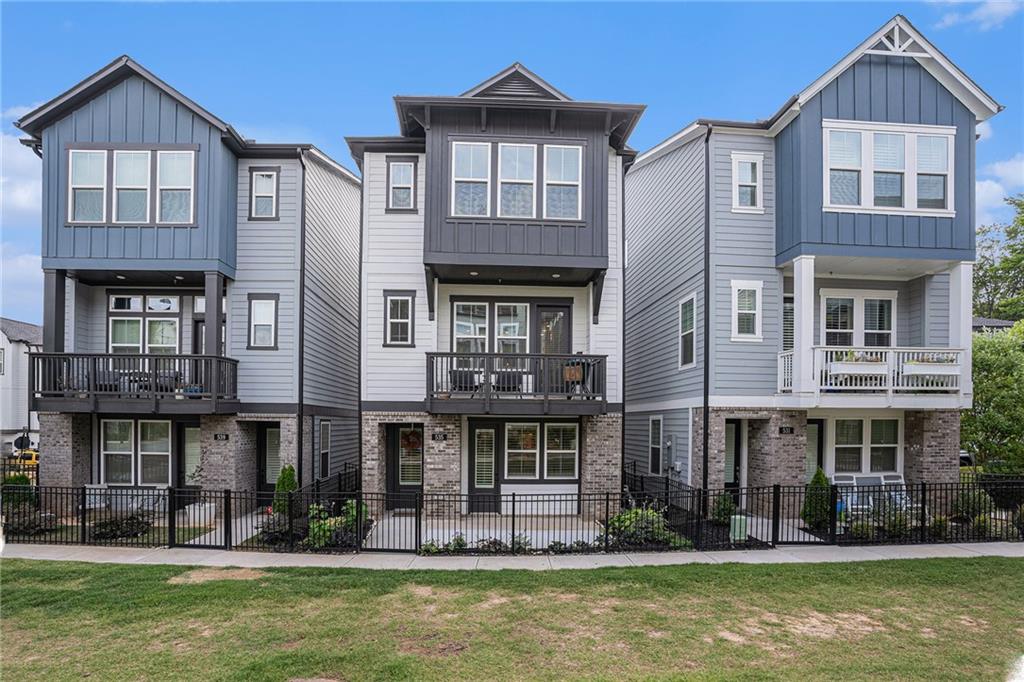 a front view of a residential apartment building with a yard