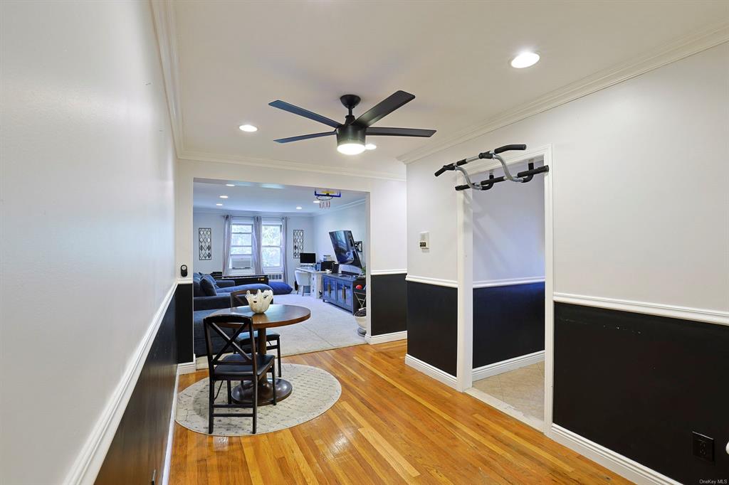 Hall featuring hardwood / wood-style flooring and ornamental molding