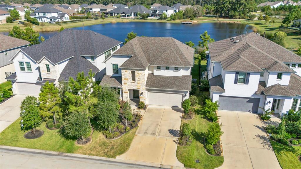 an aerial view of a house with a lake view