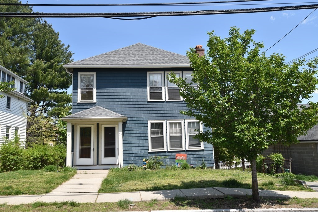 a front view of a house with a garden