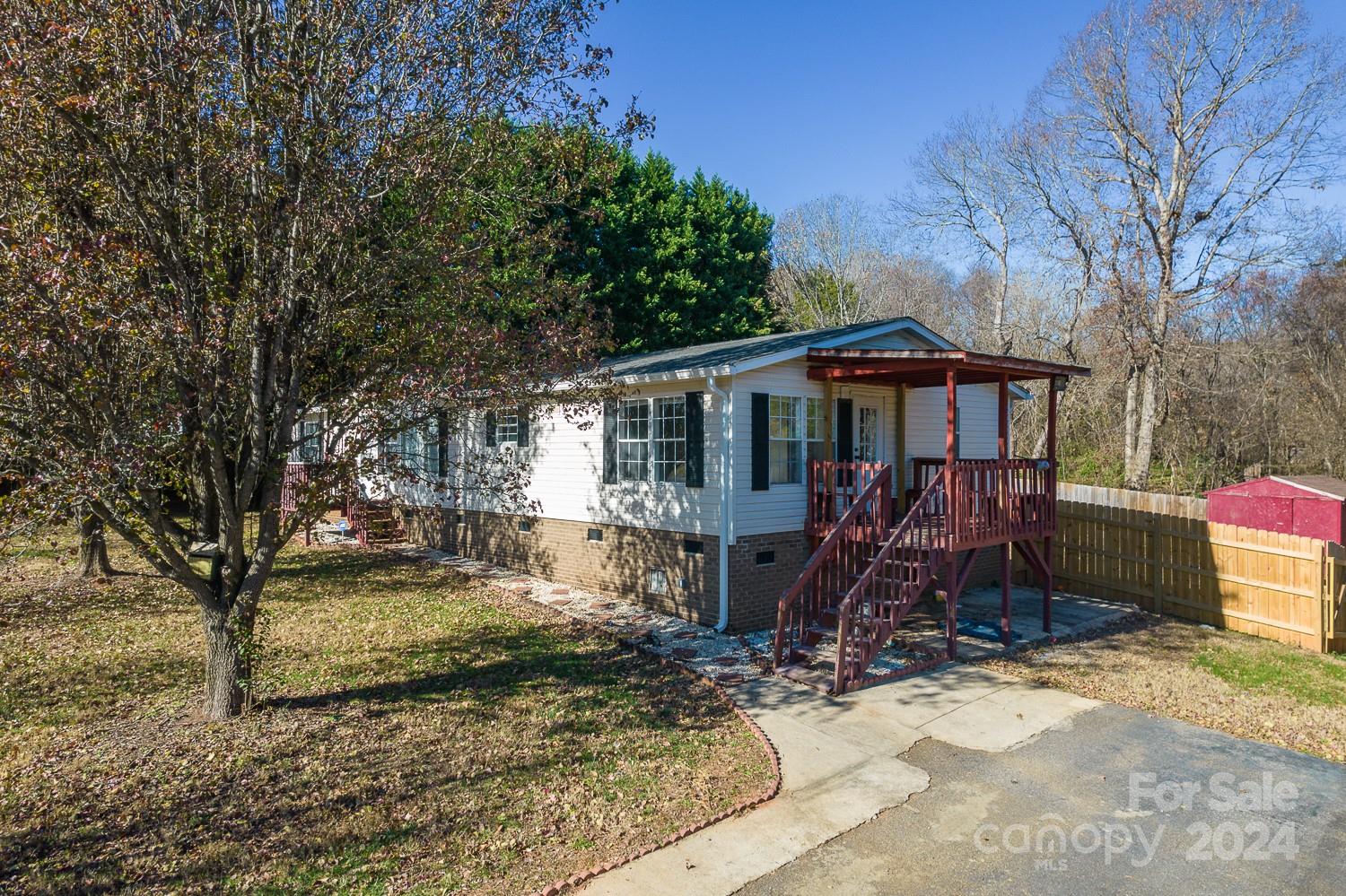 a view of a house with a yard covered in snow