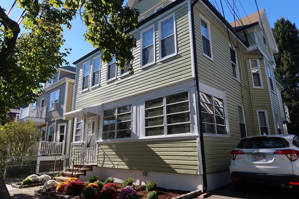 a front view of a house with parking space