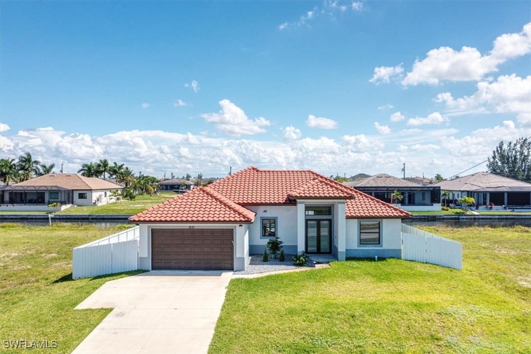 a front view of a house with swimming pool and a yard