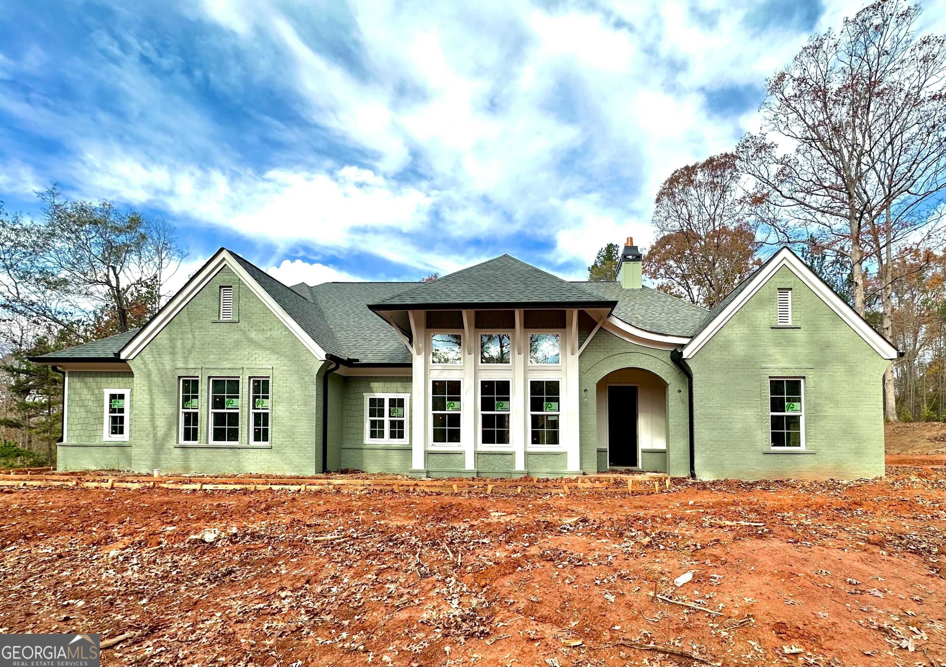 a front view of a house with a garden