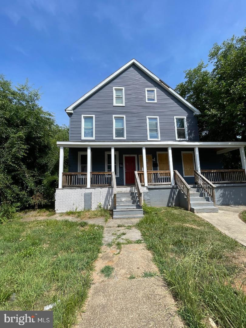 a front view of a house with yard and porch