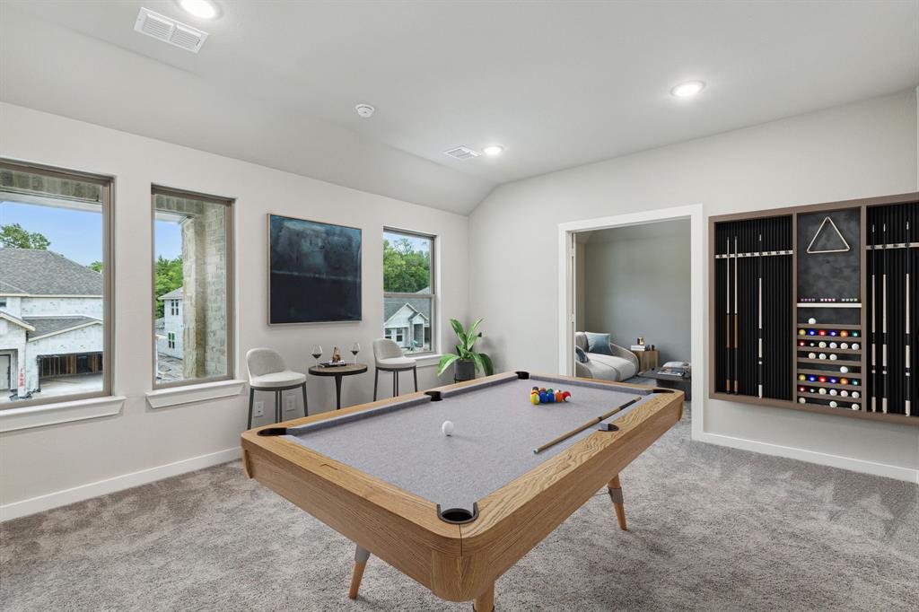 a living room with furniture a flat screen tv and floor to ceiling window