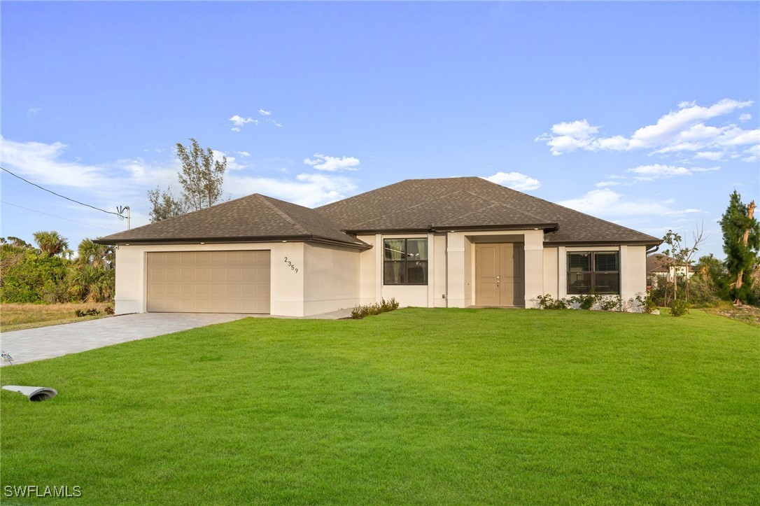 a front view of a house with a garden and yard