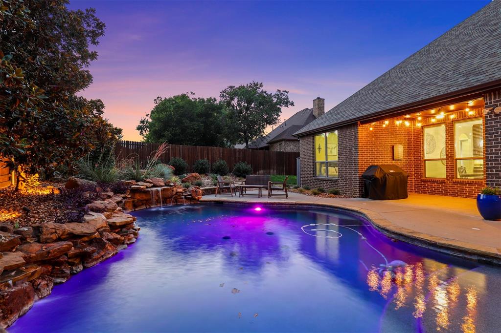 a swimming pool with outdoor seating and yard