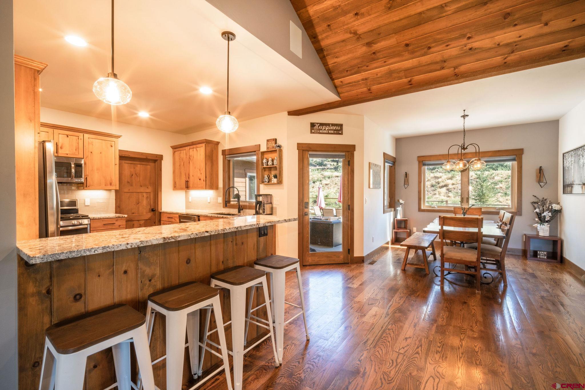 a large kitchen with lots of counter space dining table and chairs