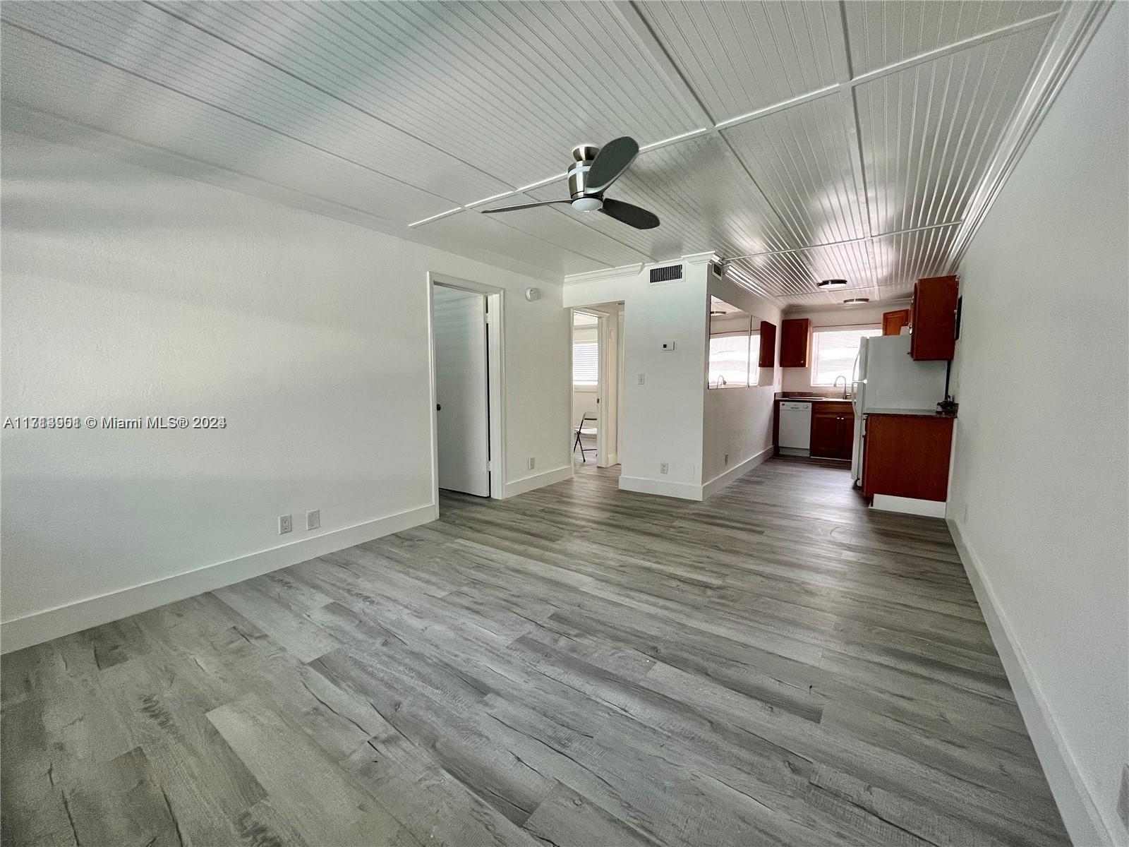 a view of a room with wooden floor