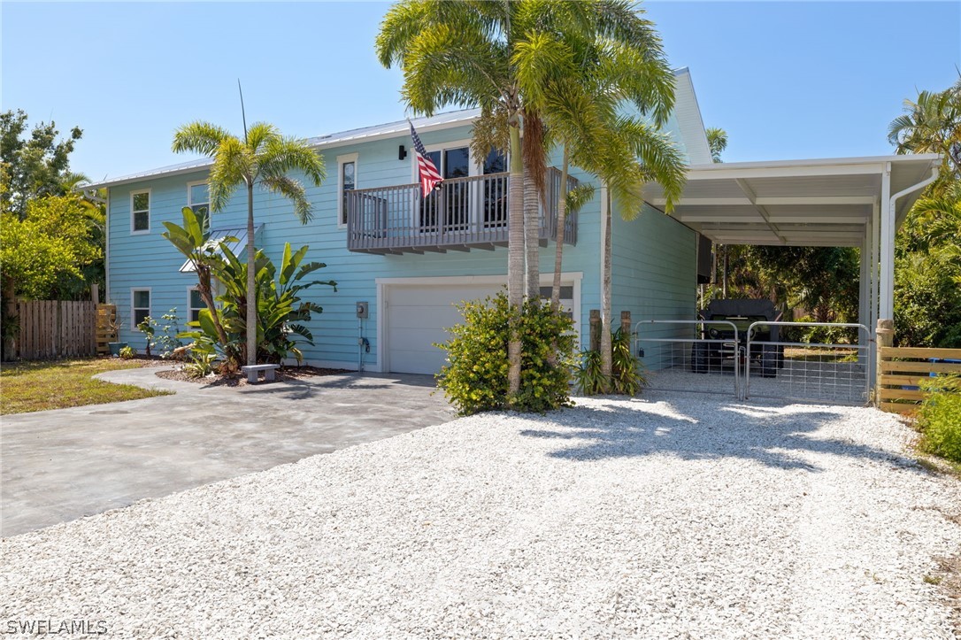 a view of a house with backyard and sitting area