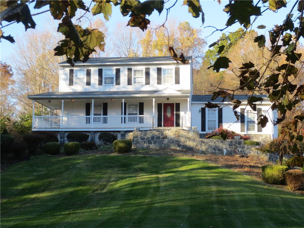 a front view of house with yard and green space