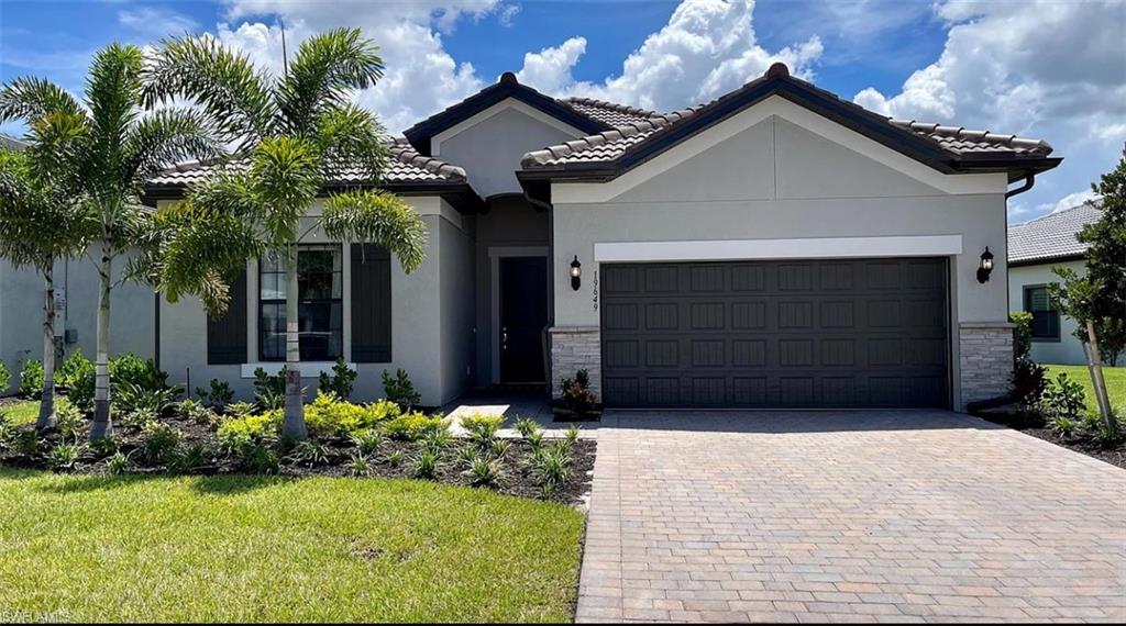 a front view of a house with a yard and garage