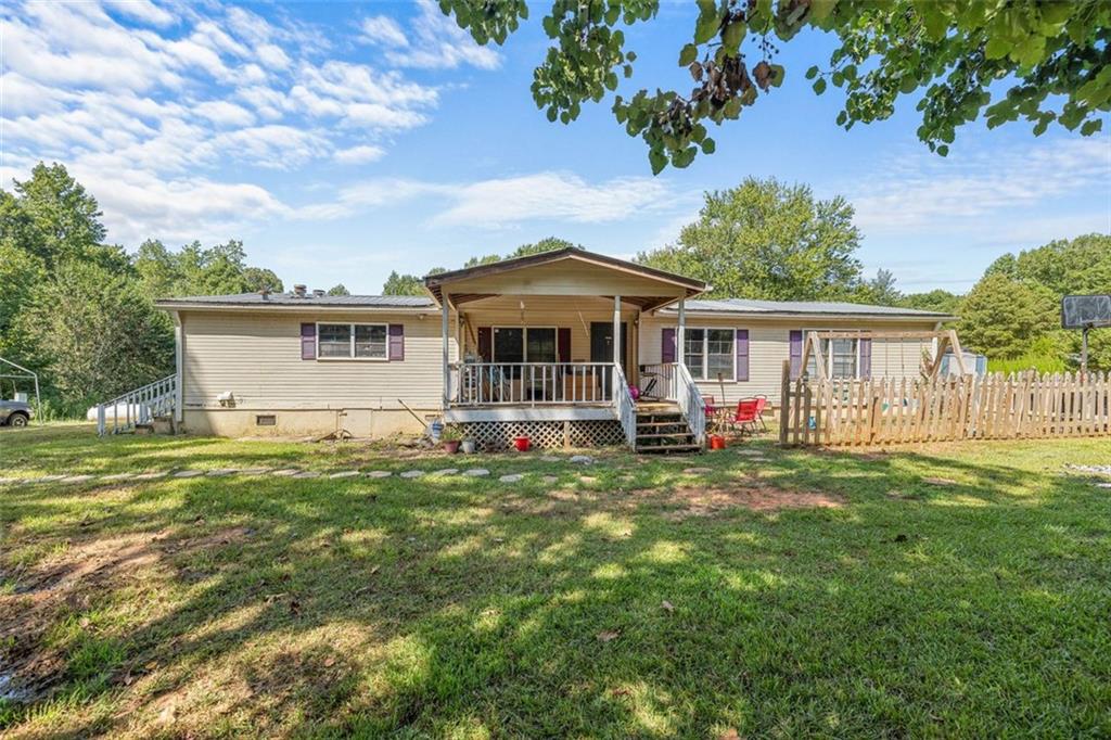 a view of a house with a backyard