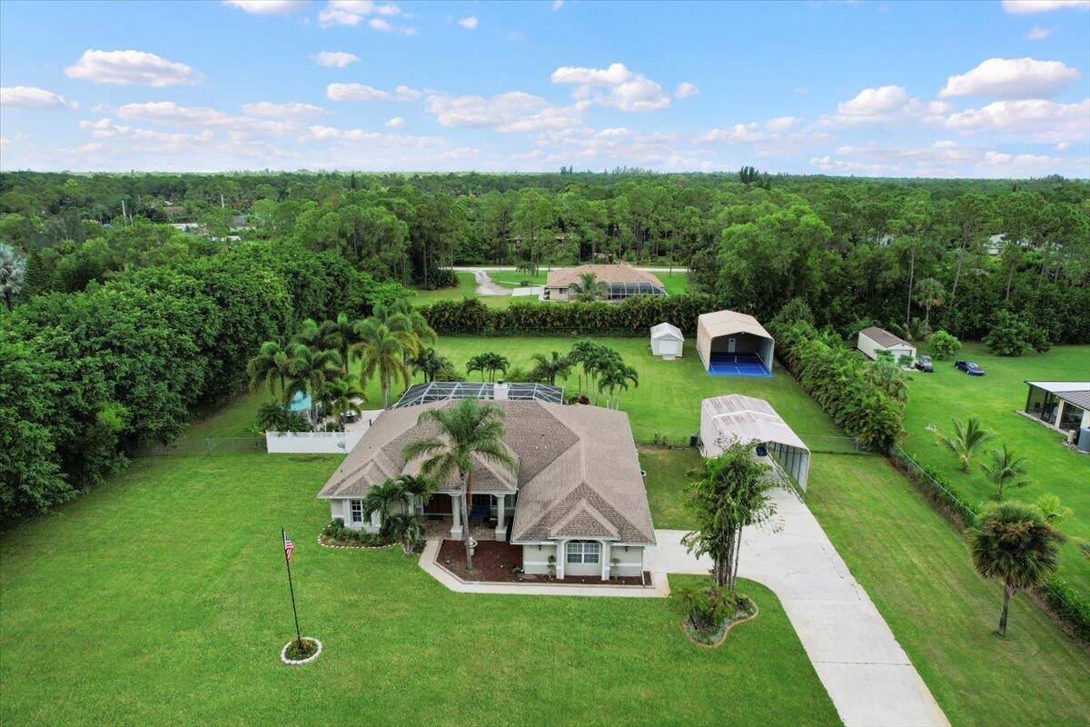 an aerial view of a house with garden space and street view