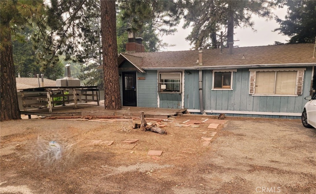 a backyard of a house with barbeque oven and outdoor seating