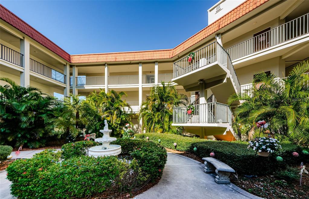 a front view of a house with a yard and outdoor seating