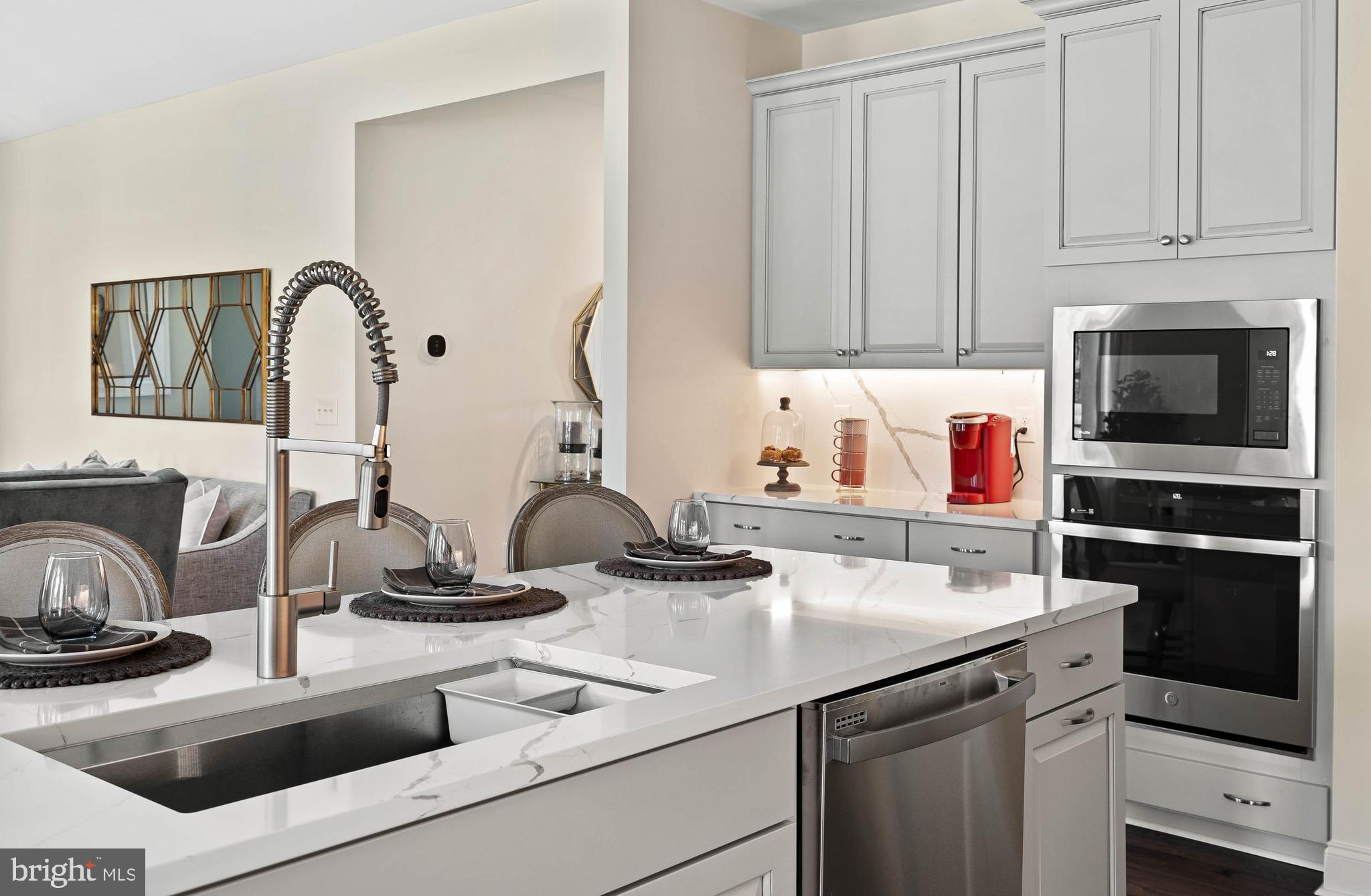 a kitchen with a sink and a stove top oven