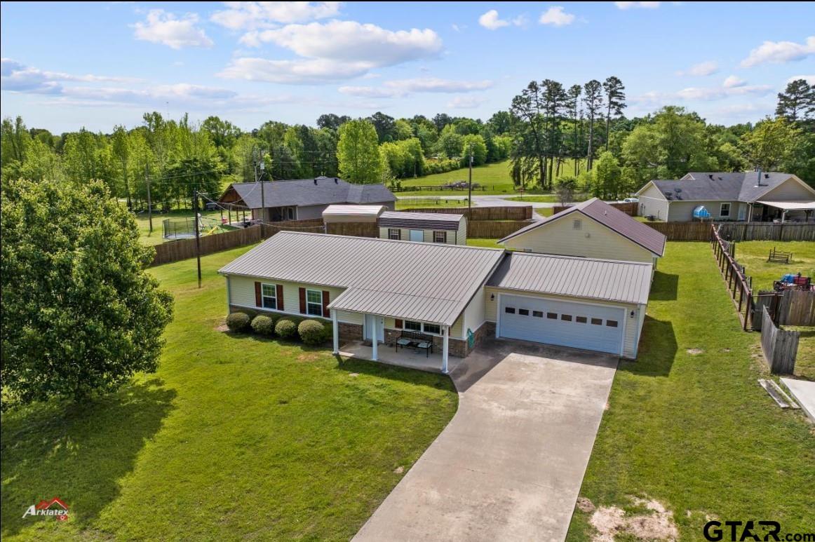 a aerial view of a house with swimming pool garden and mountain view in back