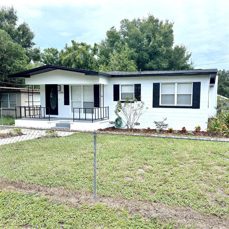 a front view of house with yard patio and green space