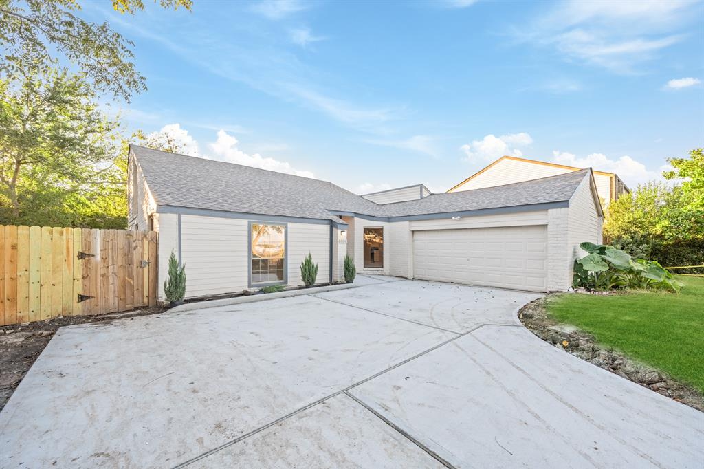 a view of a house with a yard and garage