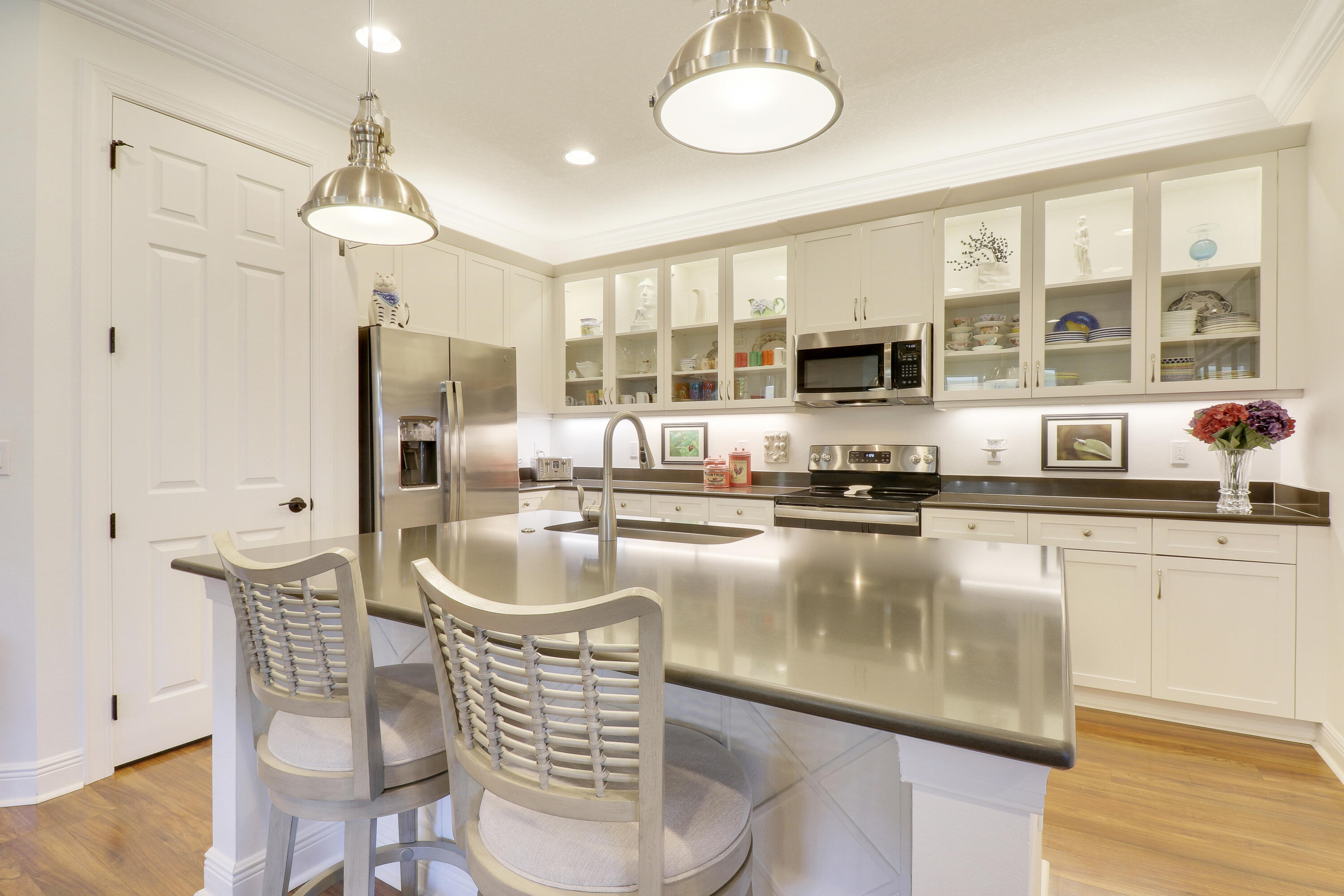 a kitchen with stainless steel appliances granite countertop a sink and a refrigerator