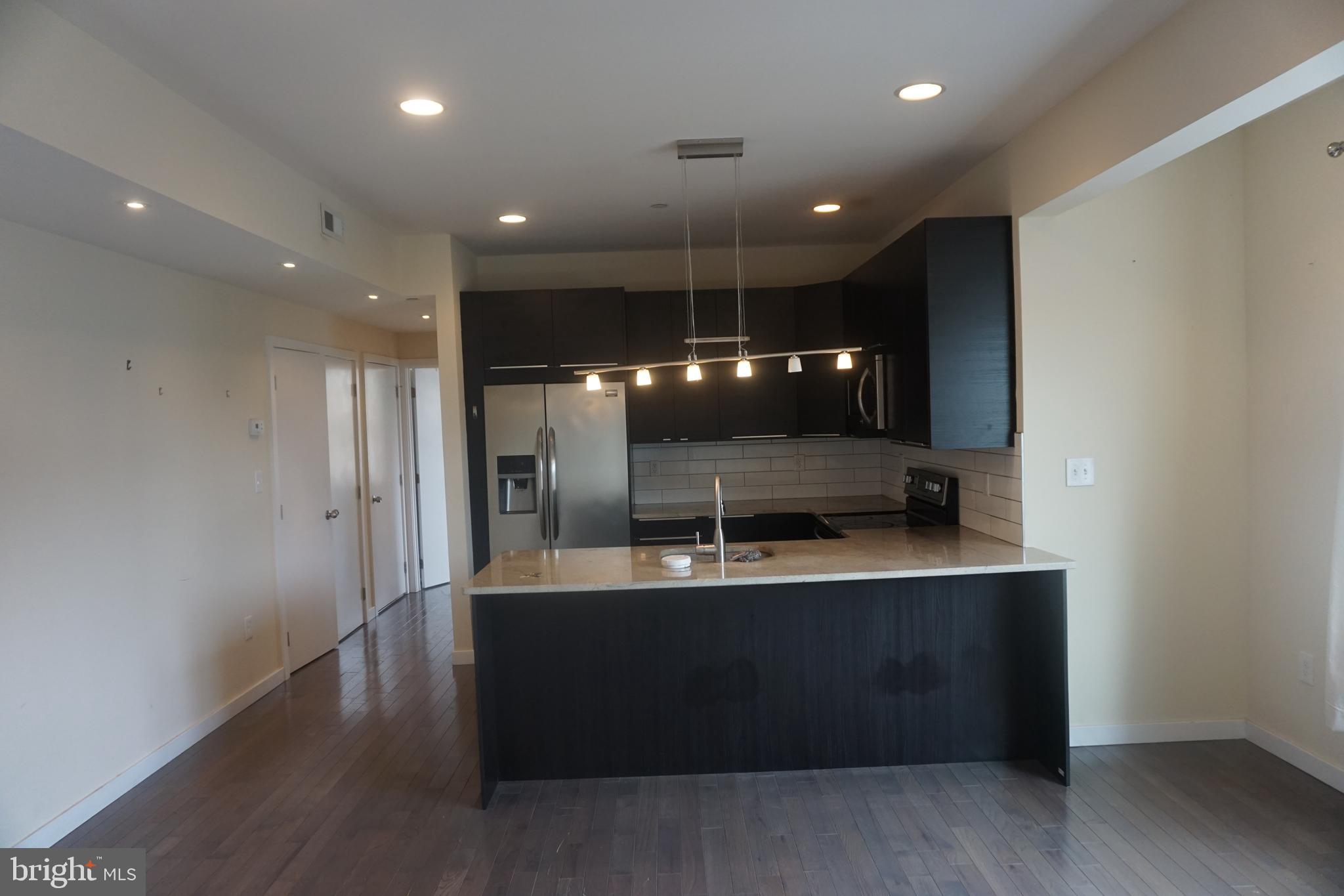 a large kitchen with a large counter top space