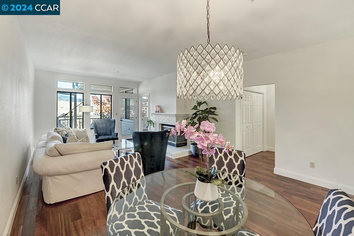 a living room with furniture chandelier and wooden floor