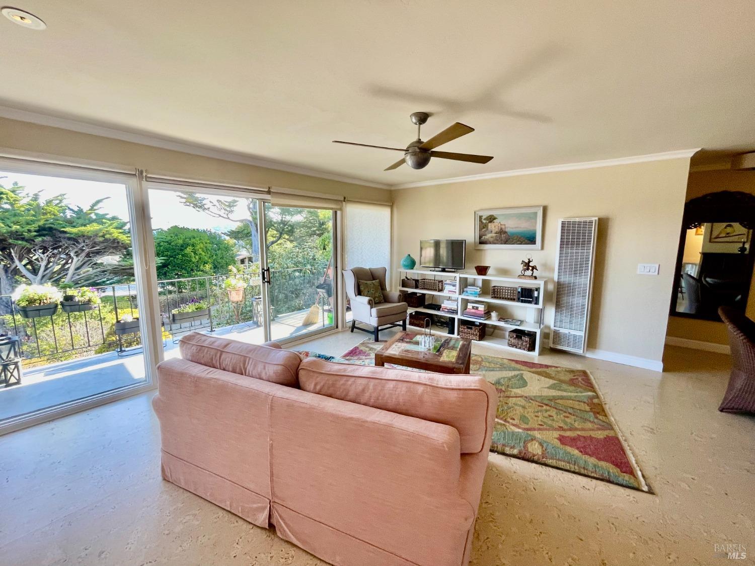 a living room with furniture and large windows