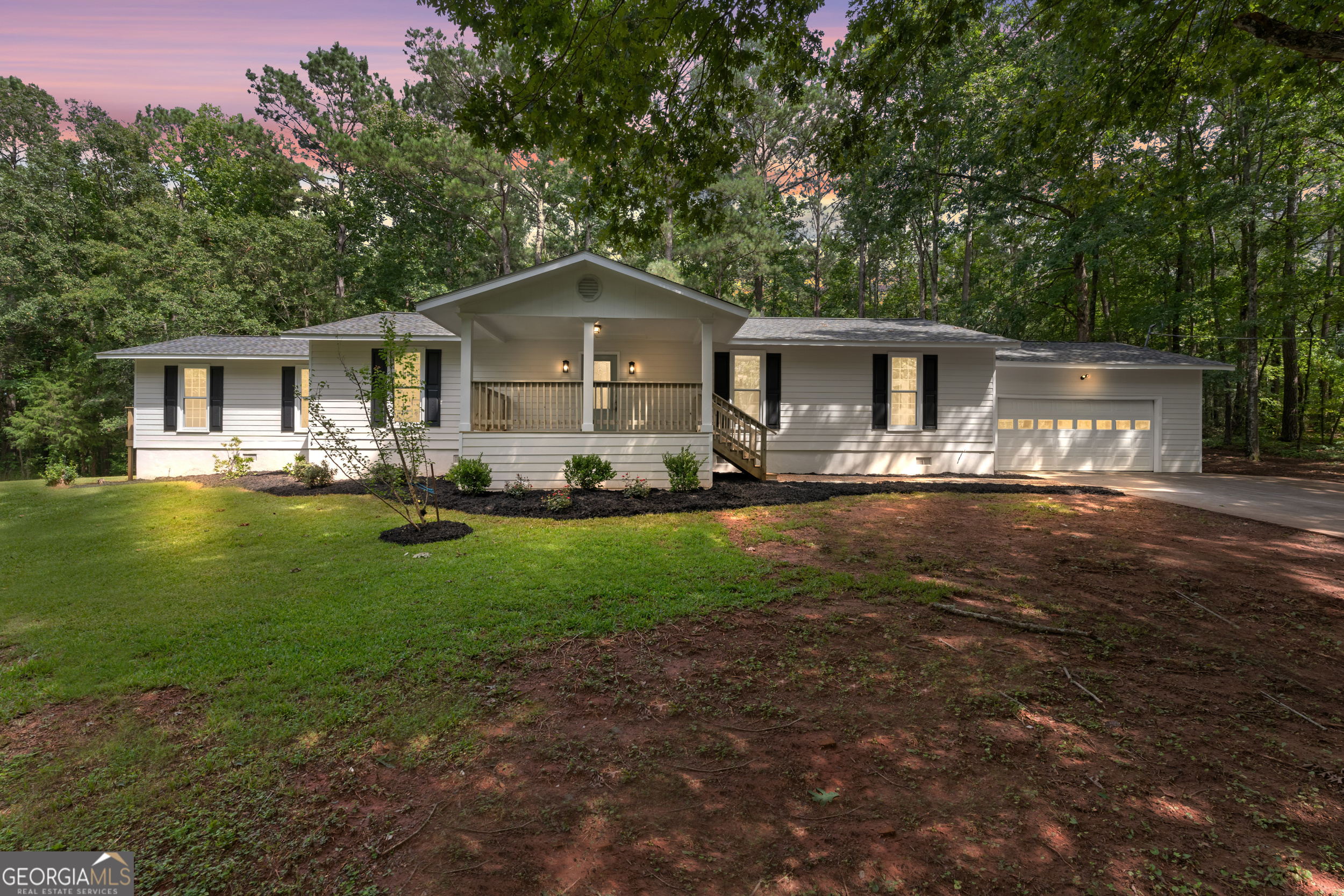 a front view of house with yard and green space