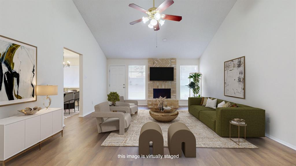 a living room with furniture a fireplace and a flat screen tv