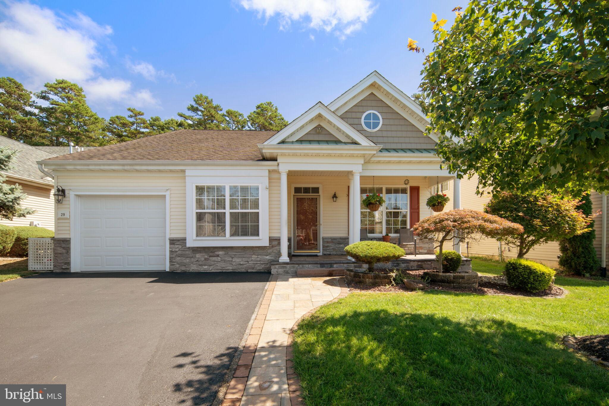 a front view of a house with sitting area and garden