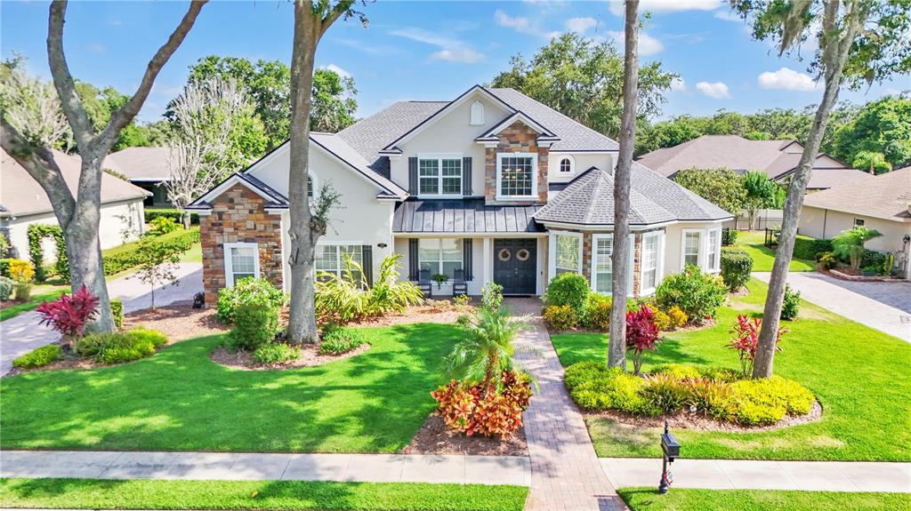 a front view of a house with a yard and fountain