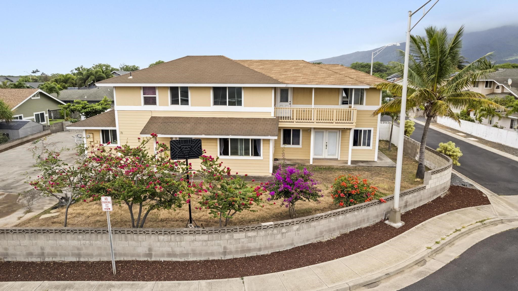 a front view of a house with a garden