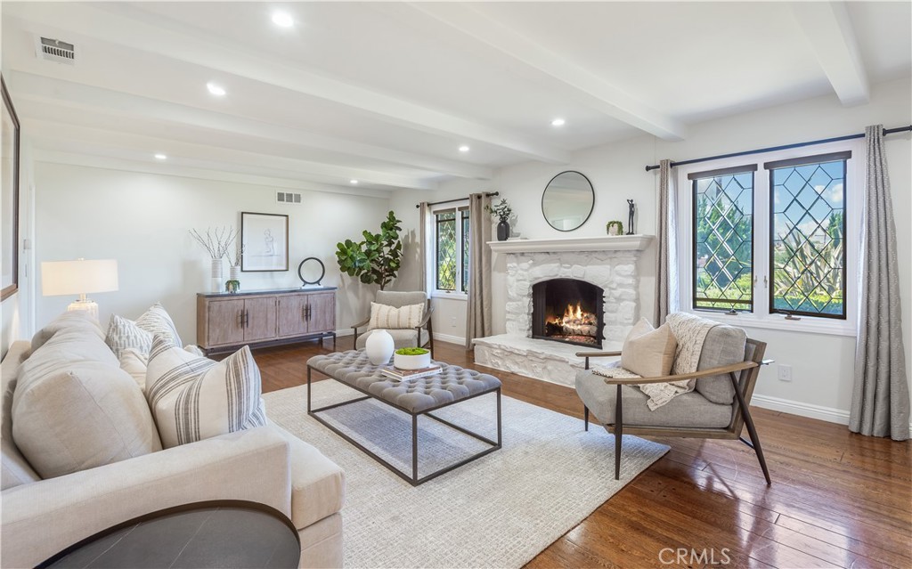 a living room with furniture a fireplace and a window