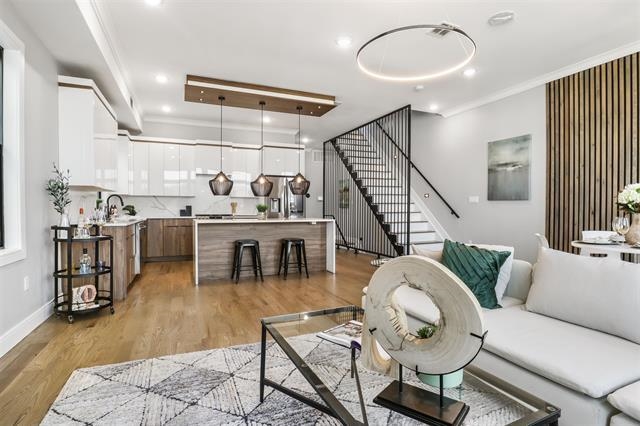 a living room with lots of furniture and kitchen view