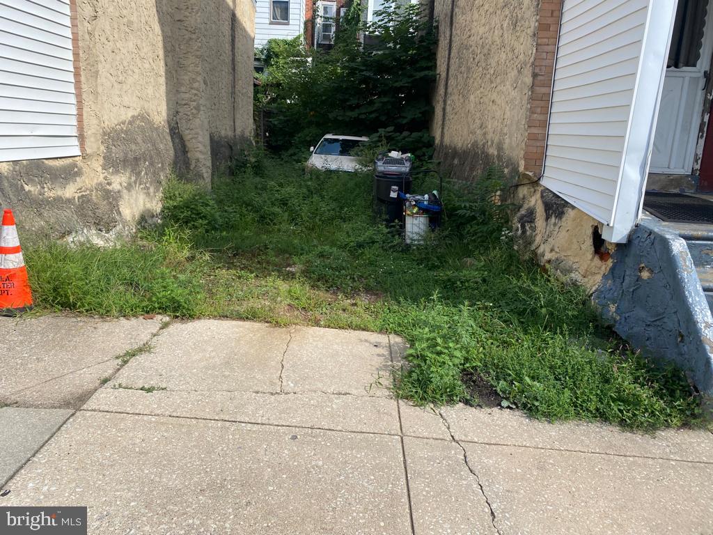 a view of backyard with plants and outdoor seating