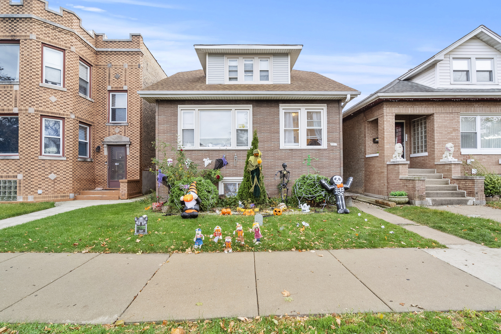 a front view of a house with a garden