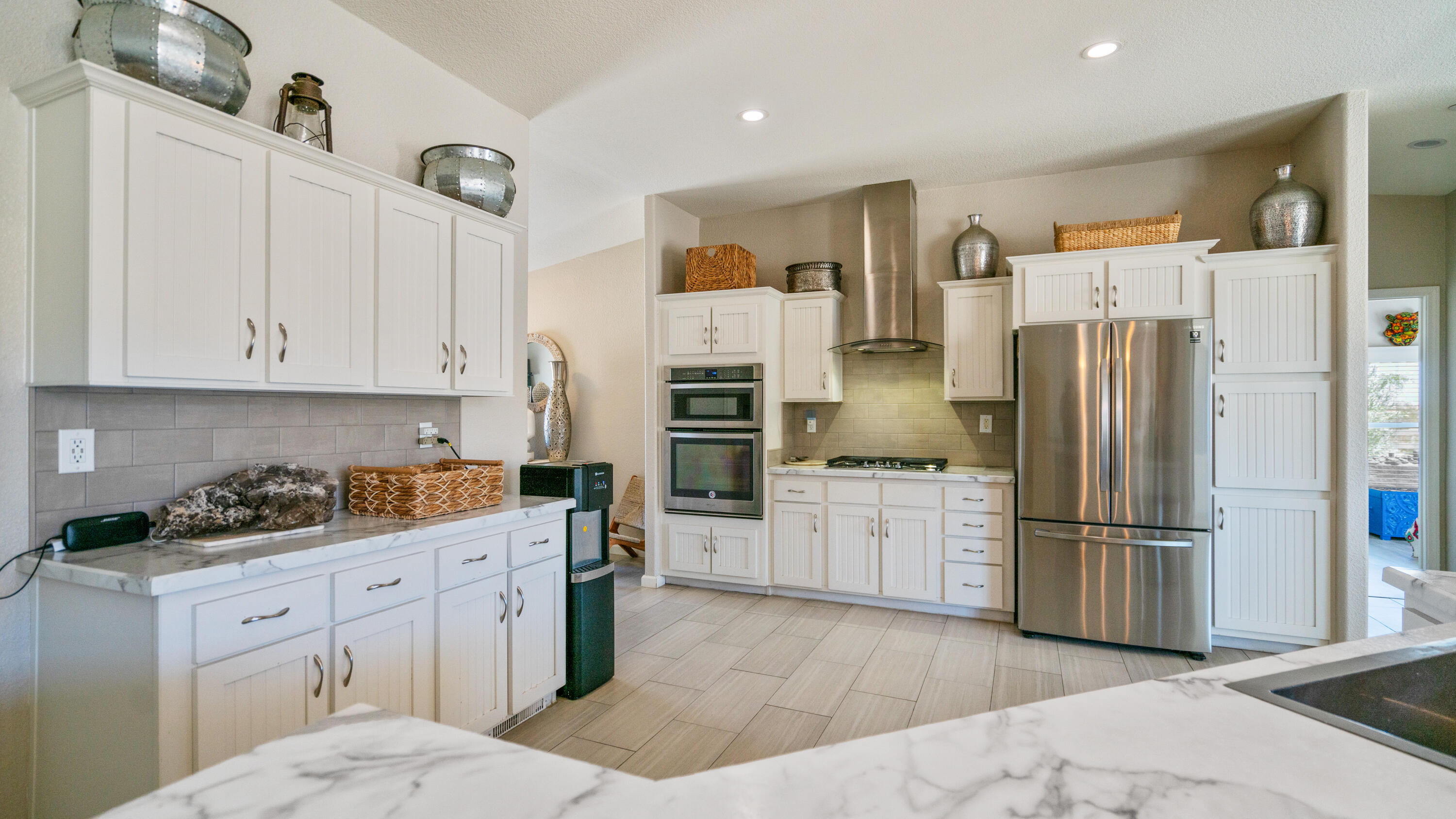 a kitchen with a refrigerator stove and cabinets