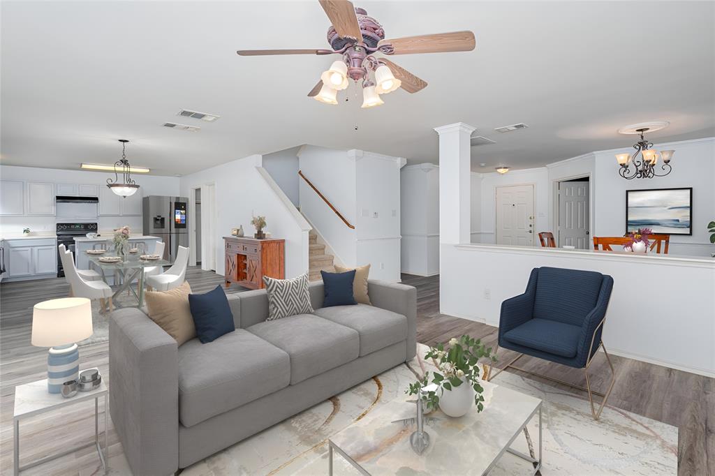 Virtually Staged Living room with ornate columns, luxury vinyl flooring, crown molding, and ceiling fan with notable chandelier