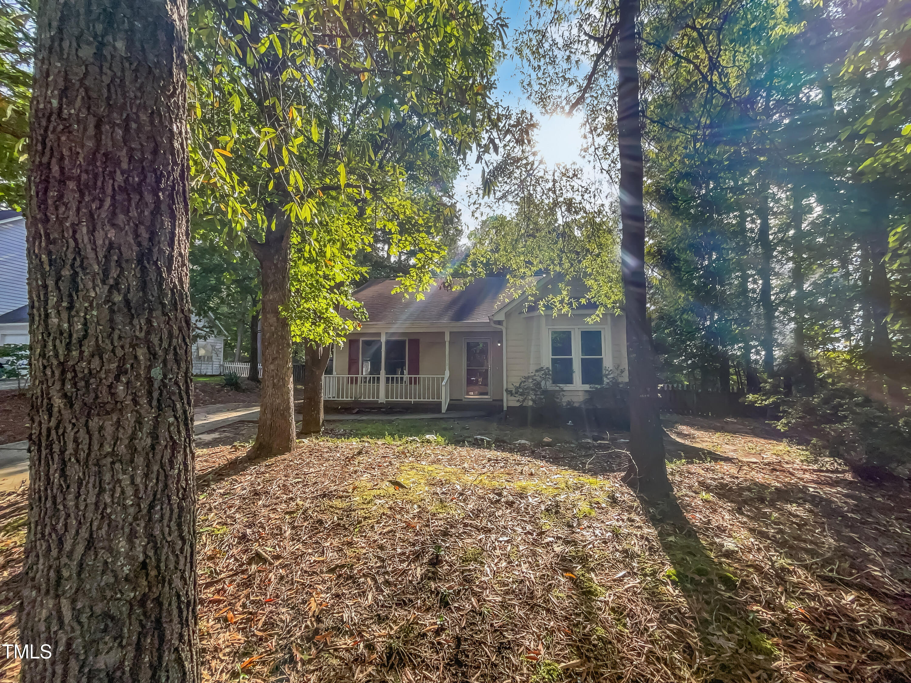 a view of a house with a tree in the yard