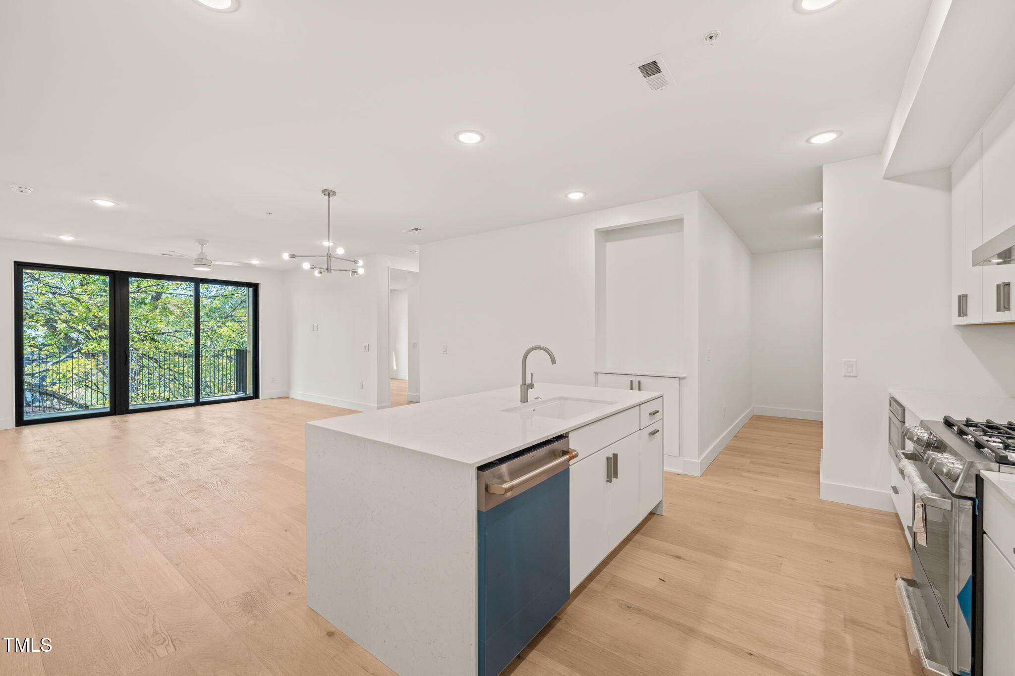 a spacious bathroom with a granite countertop sink a large mirror and a bathtub