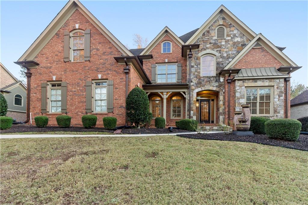 a front view of a house with a yard