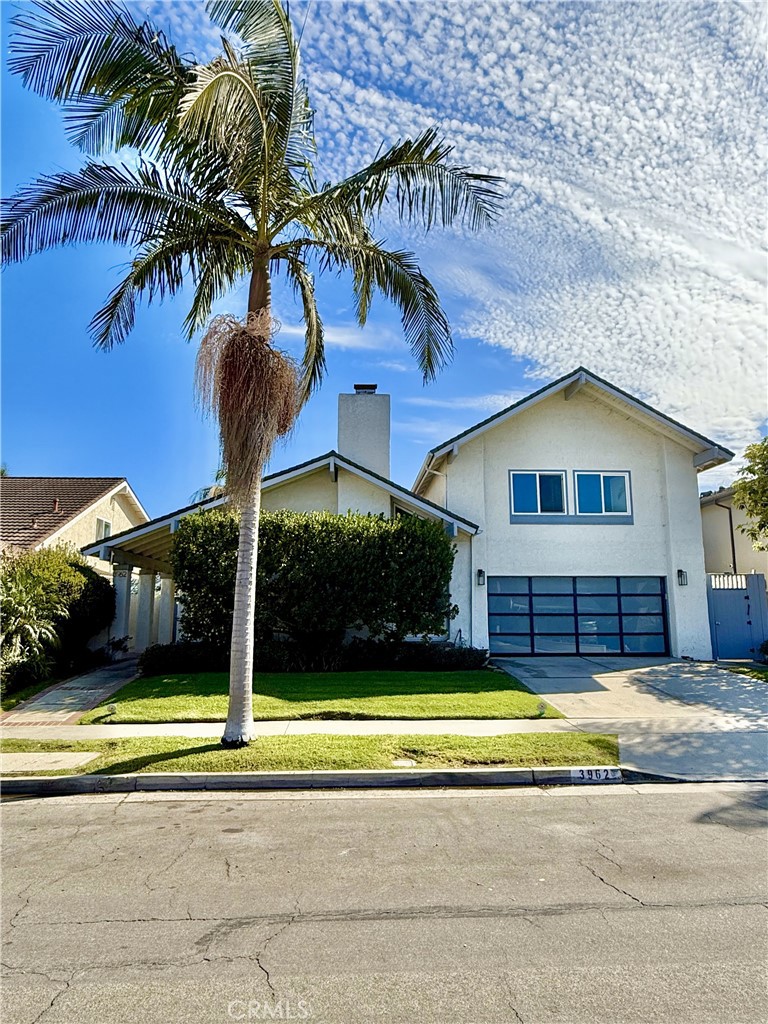 a view of a house with swimming pool and a yard