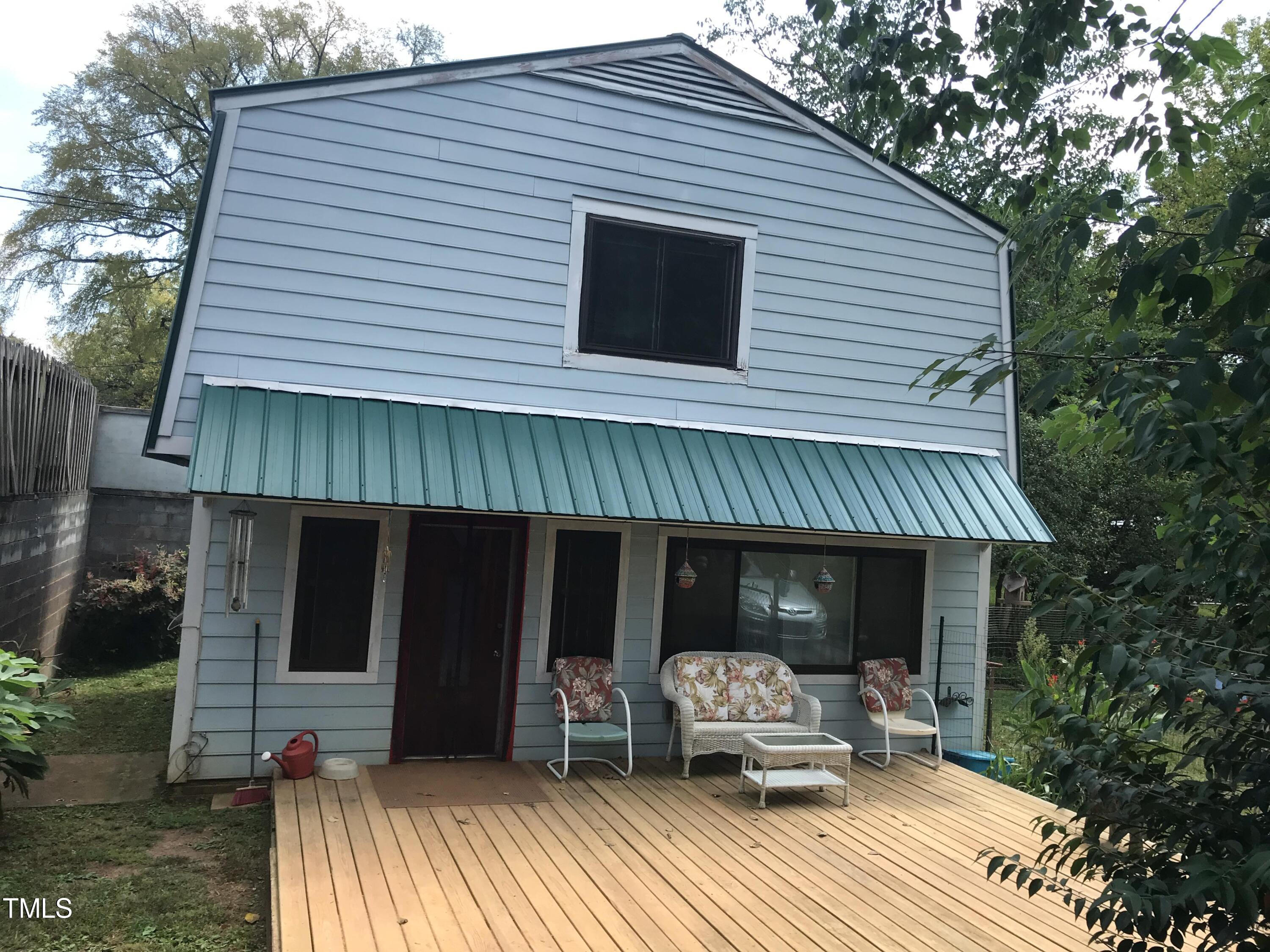 a view of a house with a yard and furniture