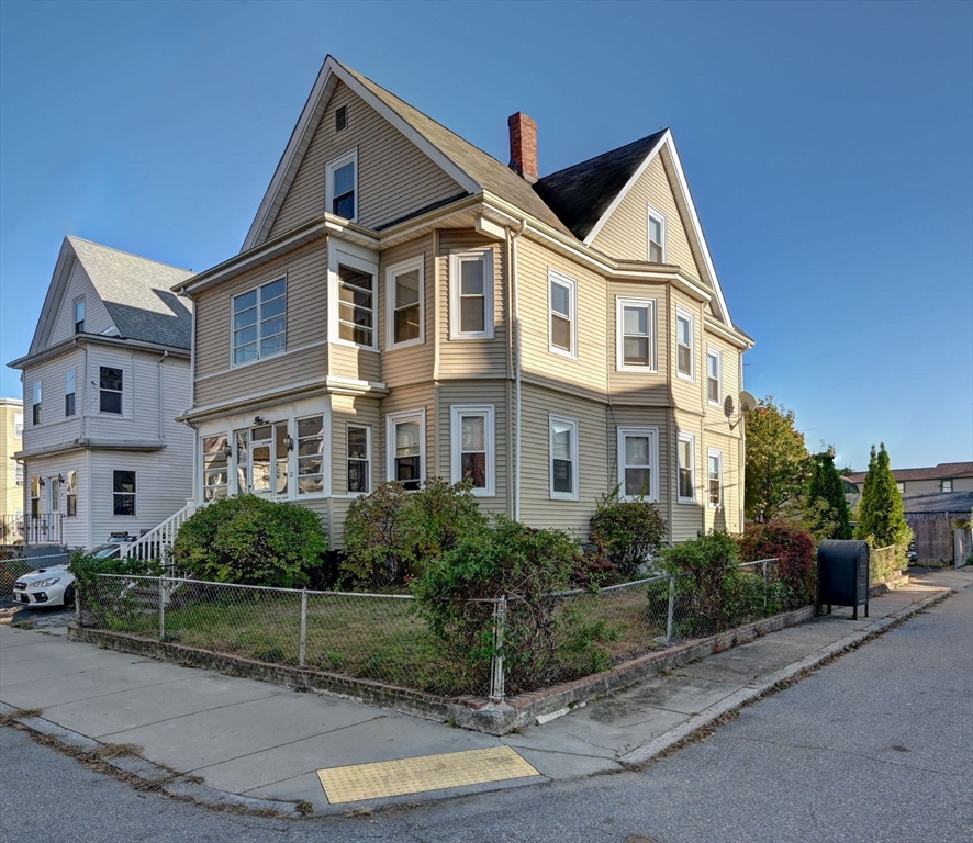 a front view of a house with plants