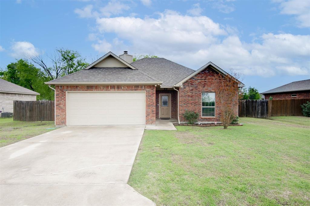 a front view of a house with a garden and yard